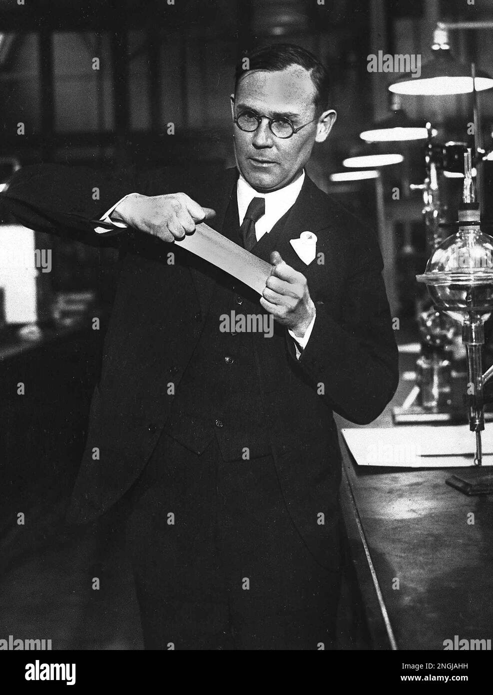 Dr. Wallace H. Carothers demonstrates a piece of his new synthetic