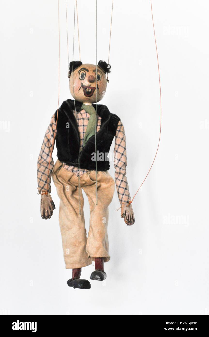 A handmade vintage puppet on a string of a clown like figure