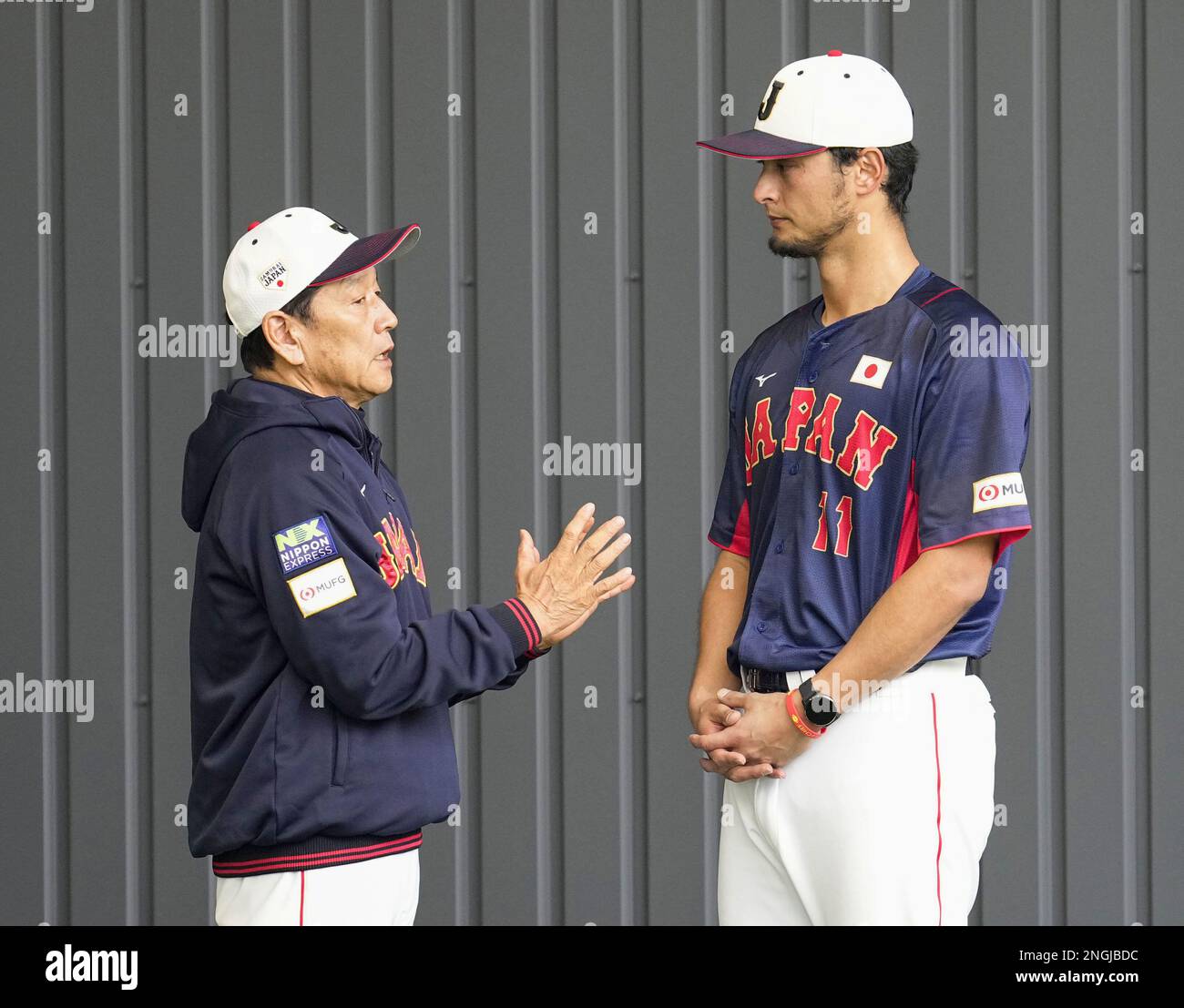 Japanese national baseball team manager Hideki Kuriyama (L) chats