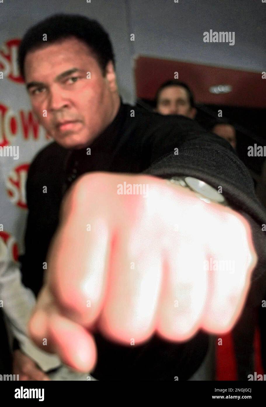 Boxing great Muhammad Ali shadow boxes with the camera as he enters the ...