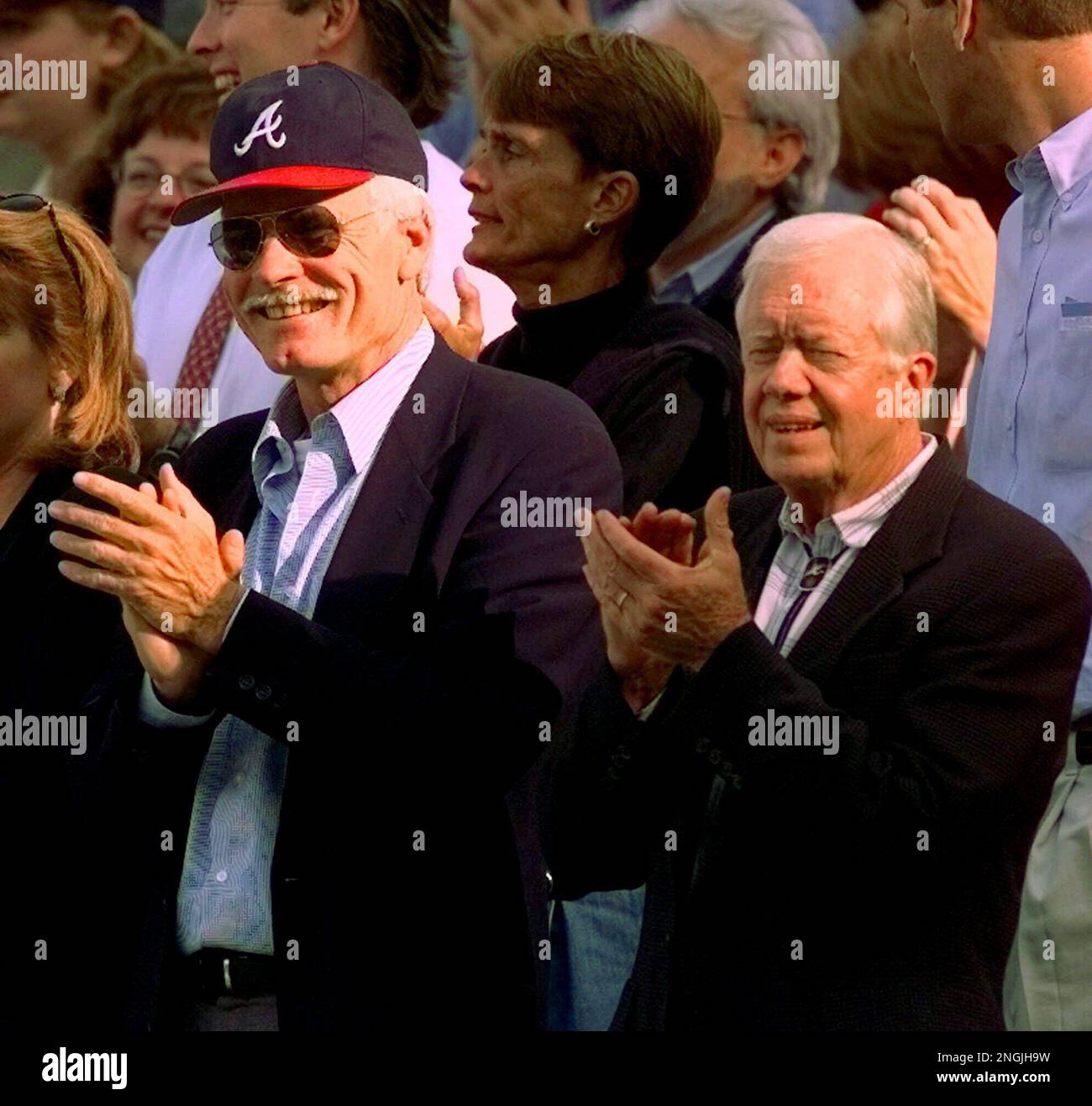 Atlanta Braves fan former President Jimmy Carter cheers during the seventh  inning stretch as a group sings God Bless America during Game 3 of the  National League Championship Series at Turner Field