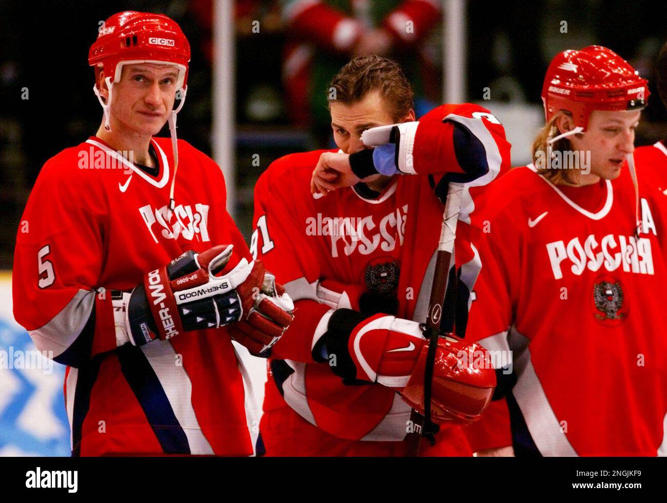 Dejected members of the Russian Olympic team, Alexei Gusarov, left, and ...