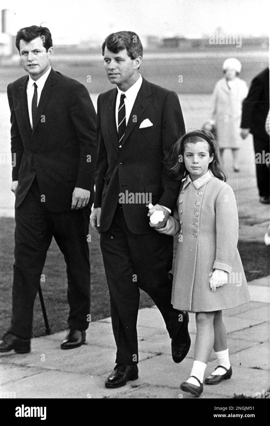Robert F. Kennedy, former U.S. Attorney General, holds the hand of his ...