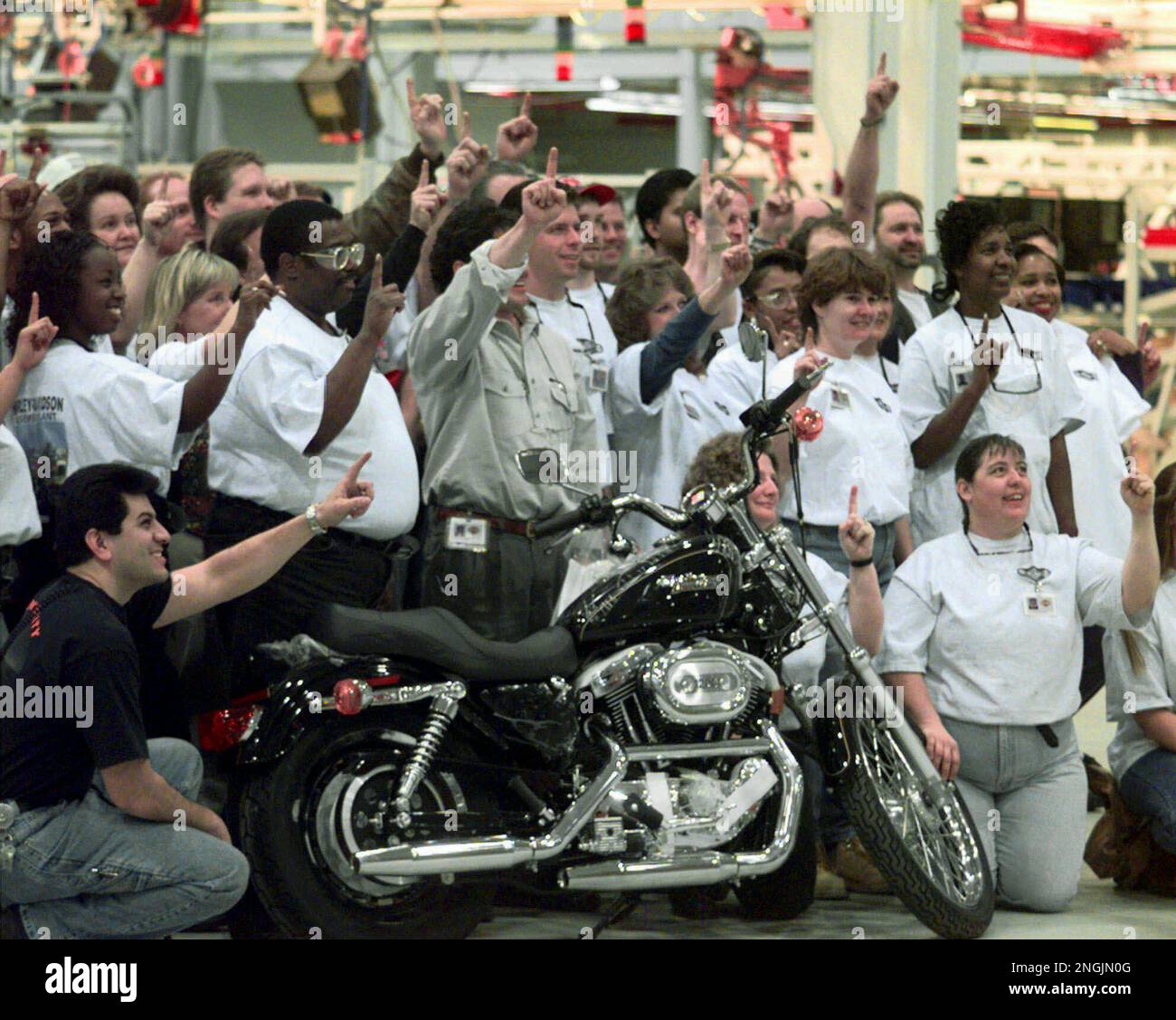 Assembly line workers at the new Harley-Davidson plant in Kansas City, Mo.,  pose for a group picture Tuesday, Jan. 6, 1998, with one of the new  Sportster motorcyles. While a number of