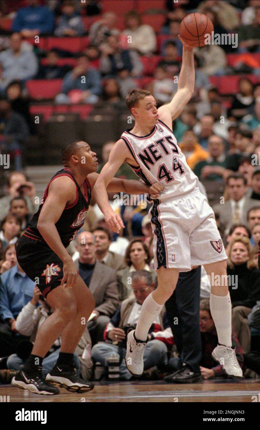 New Jersey Nets' Keith Van Horn (44) pulls down a pass as he is hand  checked by Philadelphia 76ers' Clarence Weatherspoon during the first half  Friday night, Dec. 5, 1997, in East