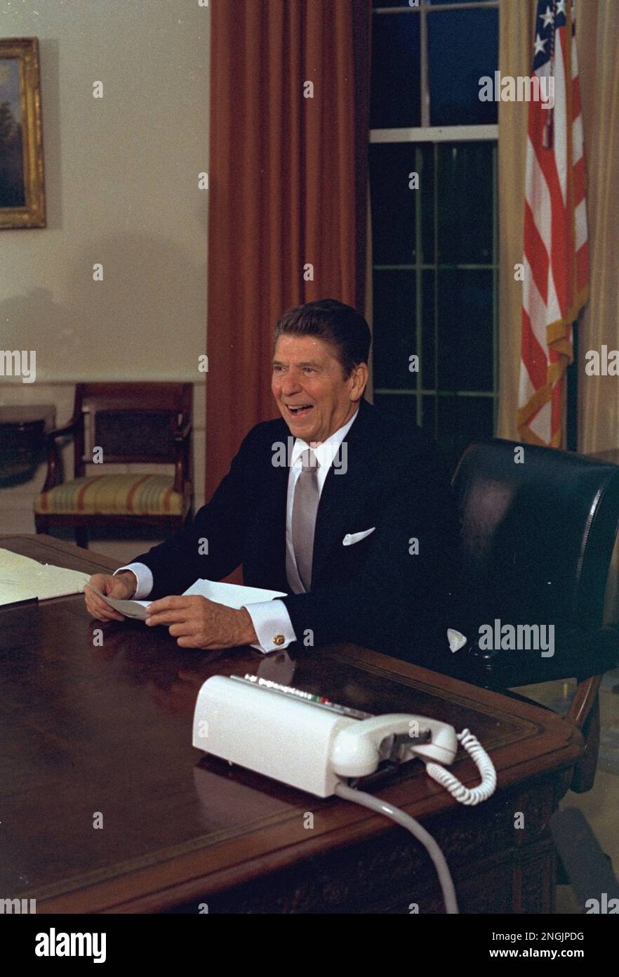 President Ronald Reagan is shown in the Oval Office of the White House ...