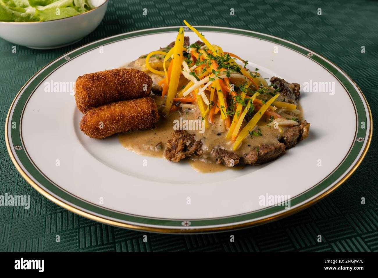 Esterhazy Roast Beef or Rostbraten with Root Vegetable Julienne, Croquettes and Sour Cream Gravy Stock Photo