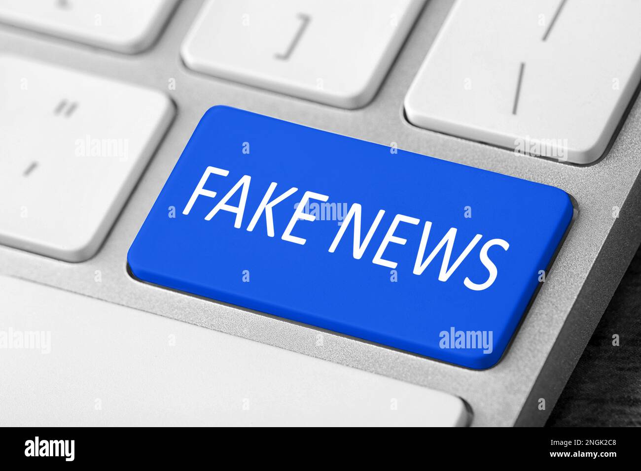 Modern computer keyboard with text FAKE NEWS on button, closeup Stock
