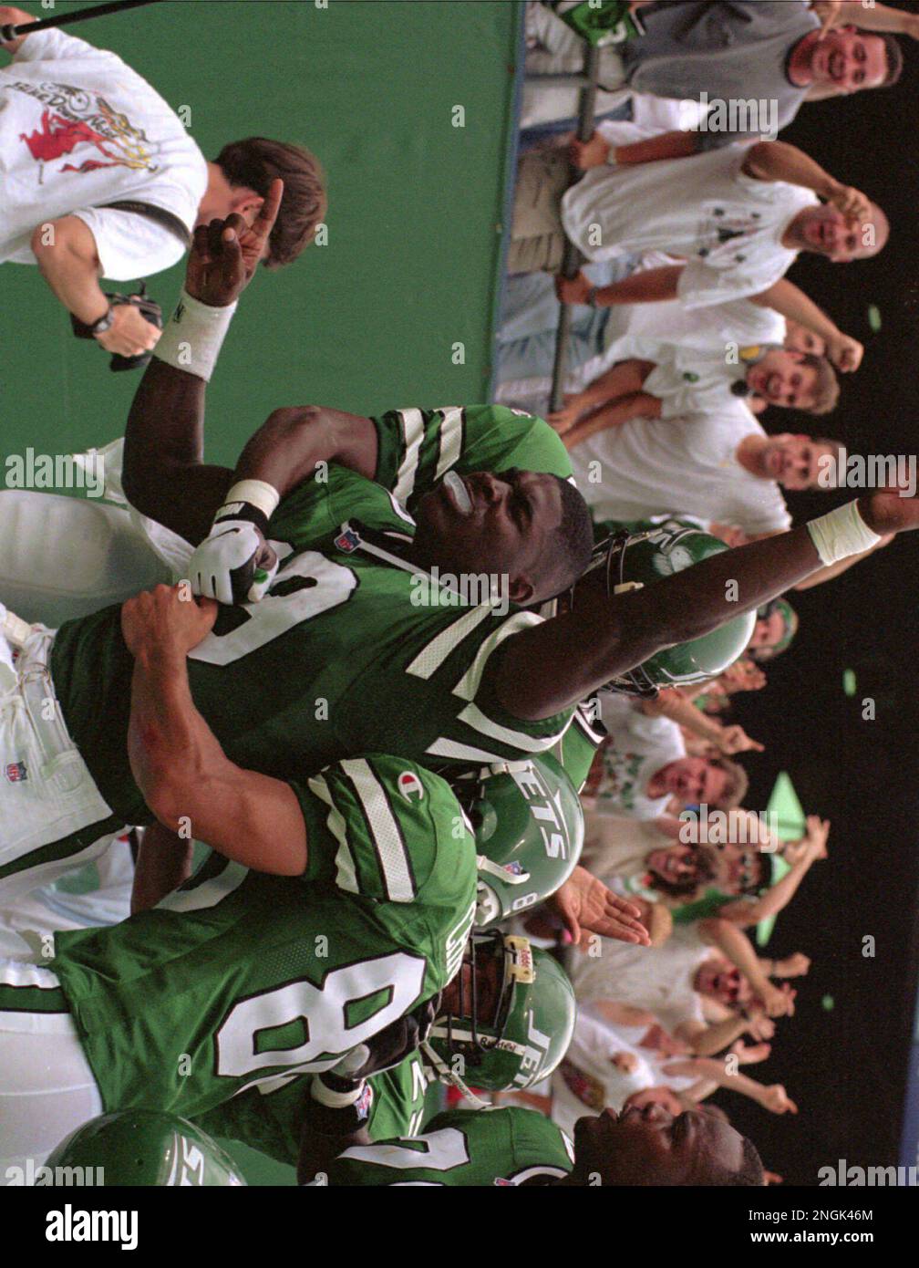 New York Jets' Keyshawn Johnson (19) gets hugged by teammates after scoring  a touchdown in the second quarter against the Indianapolis Colts Sunday,  Sept. 8, 1996, at Giants Stadium in East Rutherford,