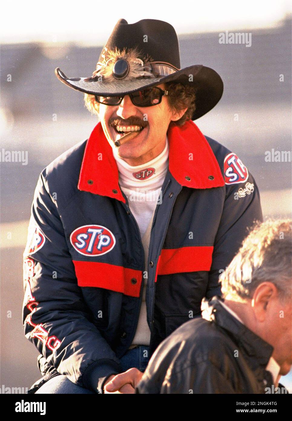 Legendary NASCAR driver Richard Petty smokes a cigar while resting ...