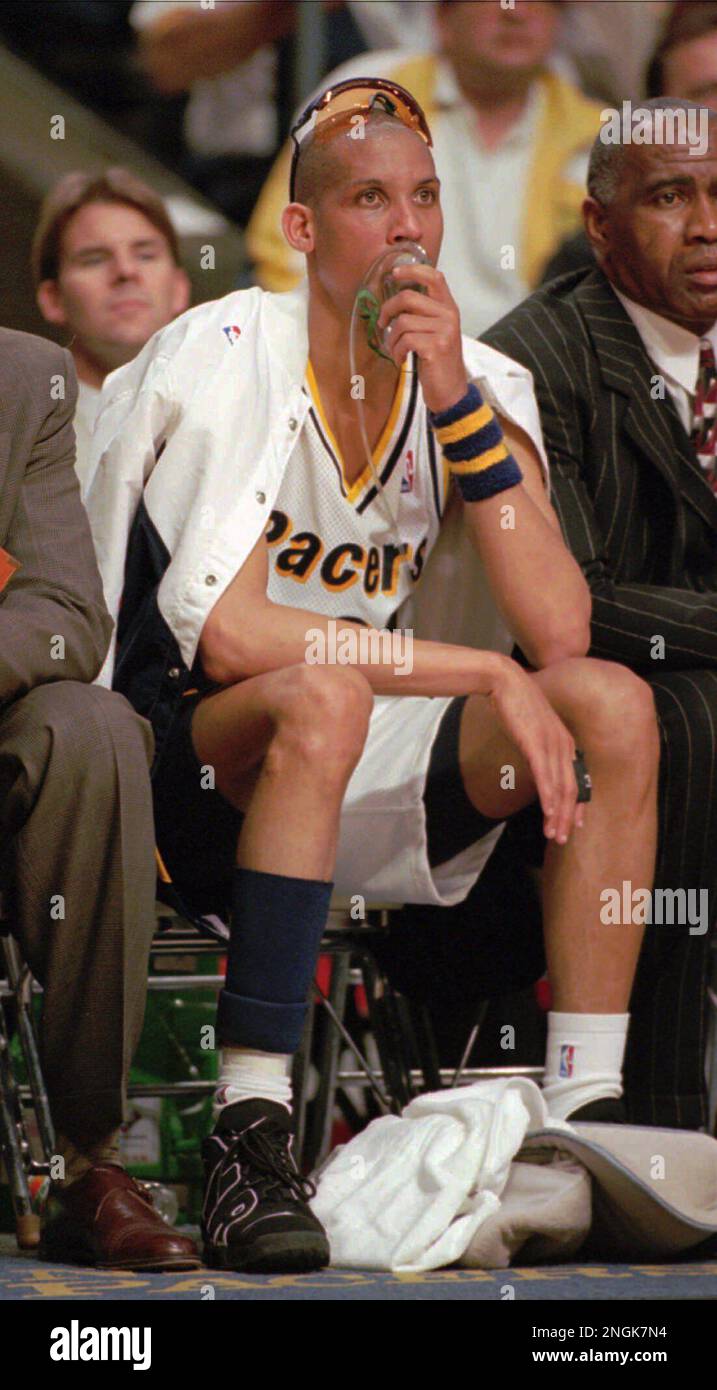 Indiana Pacers guard Reggie Miller sits on the bench and takes