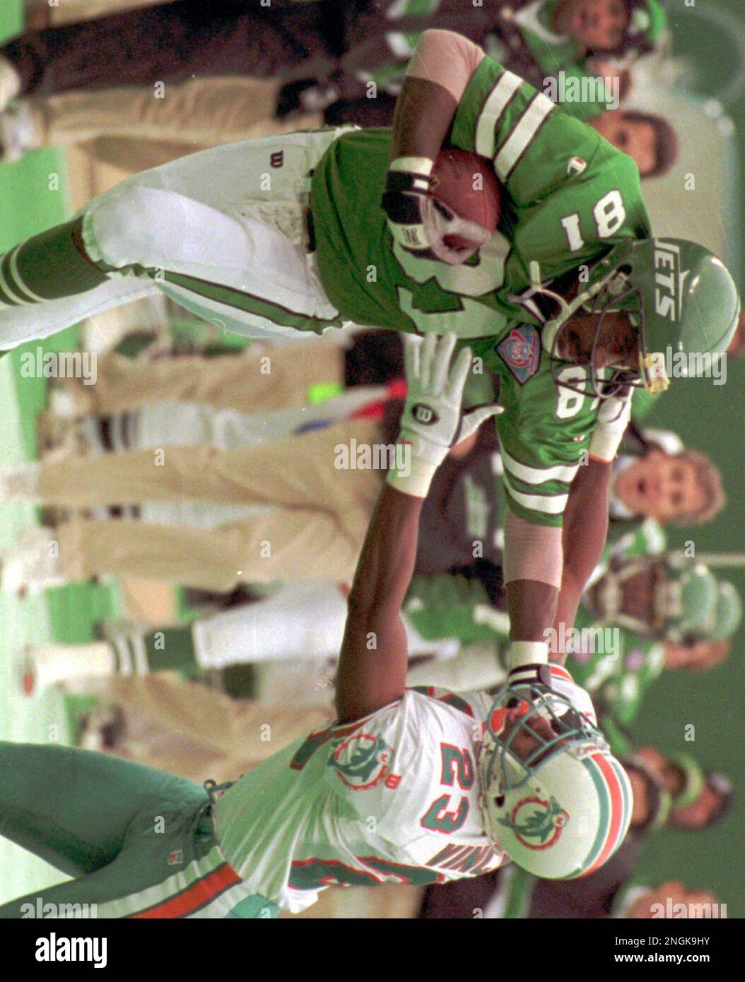 New York Jets' Art Monk, left, tries to keep Miami Dolphins' Troy Vincent  at arms length during first quarter action at Giants Stadium in East  Rutherford in this Nov. 27, 1994 photo.