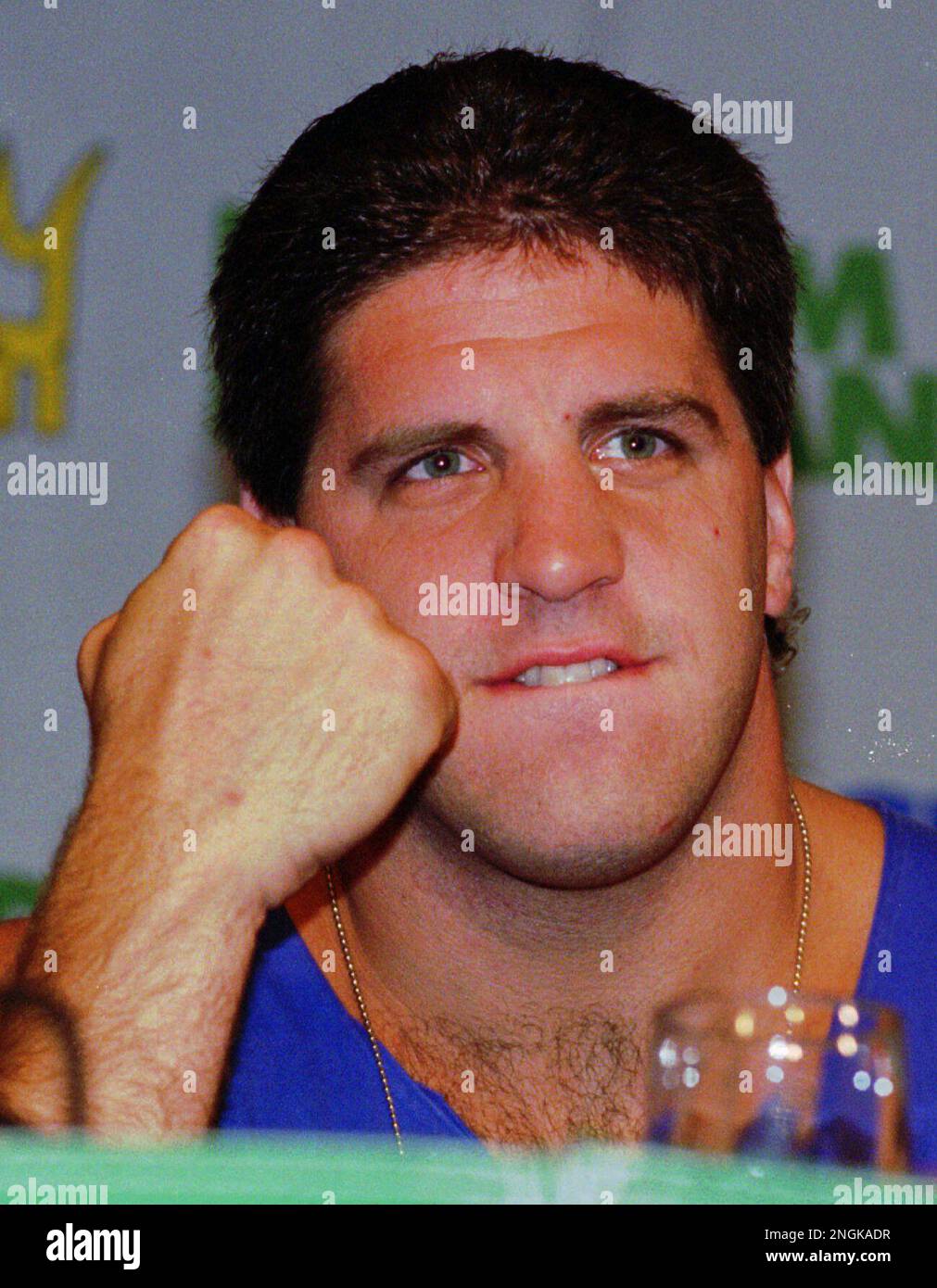 Heavyweight challenger Peter McNeeley clenches a fist during a news