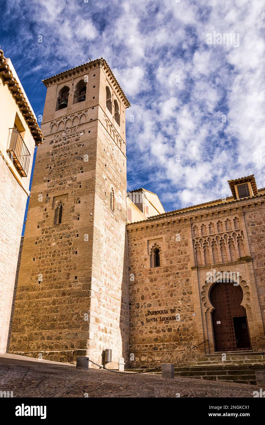 Bell tower and facade of a church in the historic center of Toledo with an Islamic-style door. Stock Photo