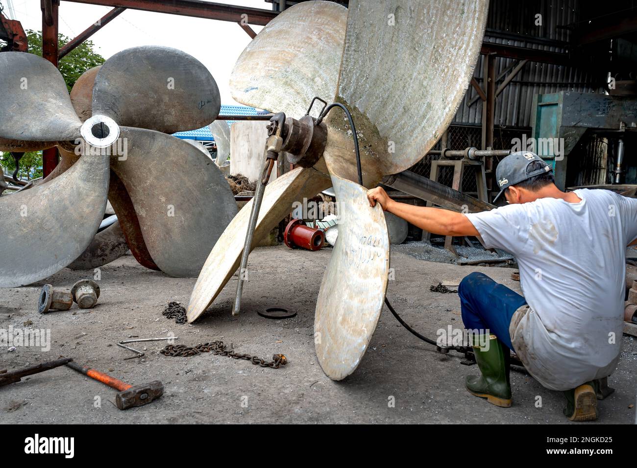 Workers repair propellers for fishing boats in Rach Gia City, Kien