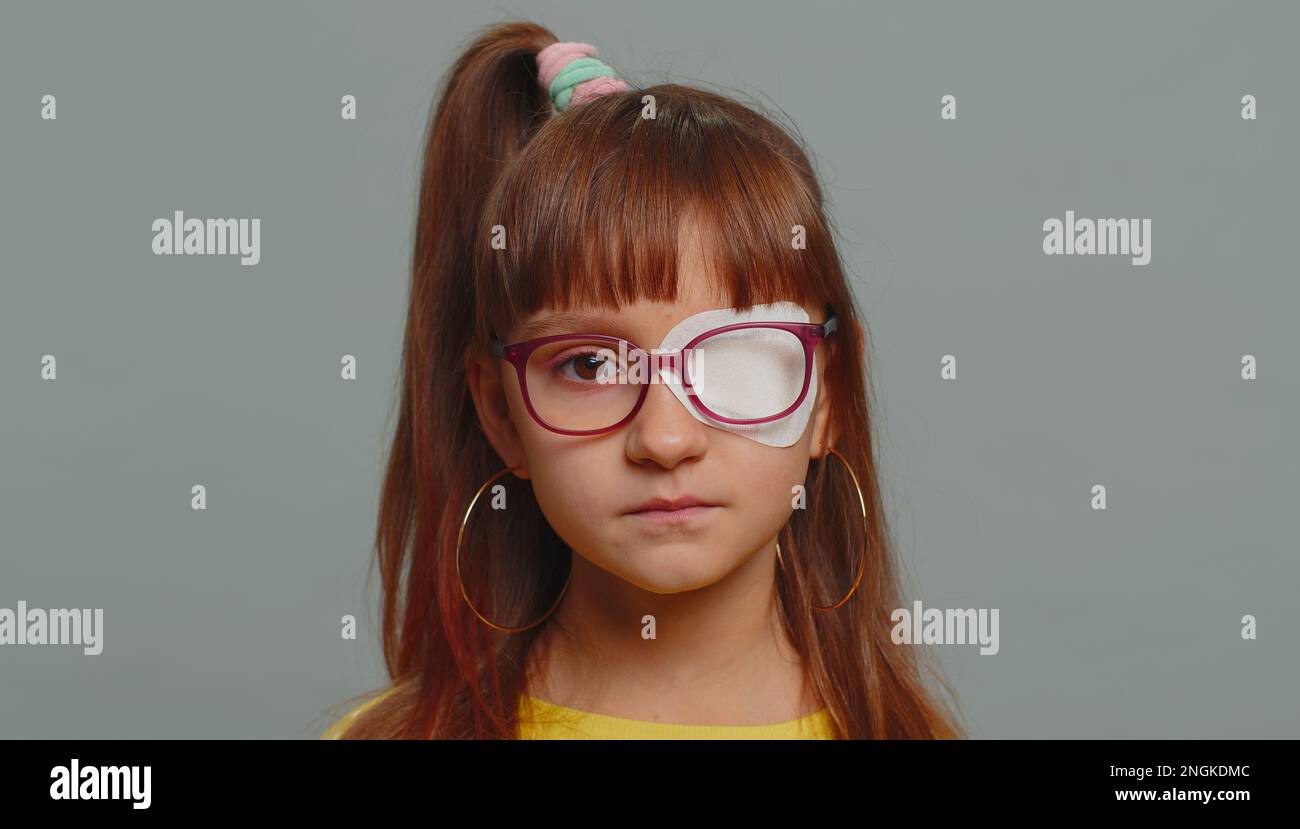 Sick ill preteen girl looking at camera having protective bandage
