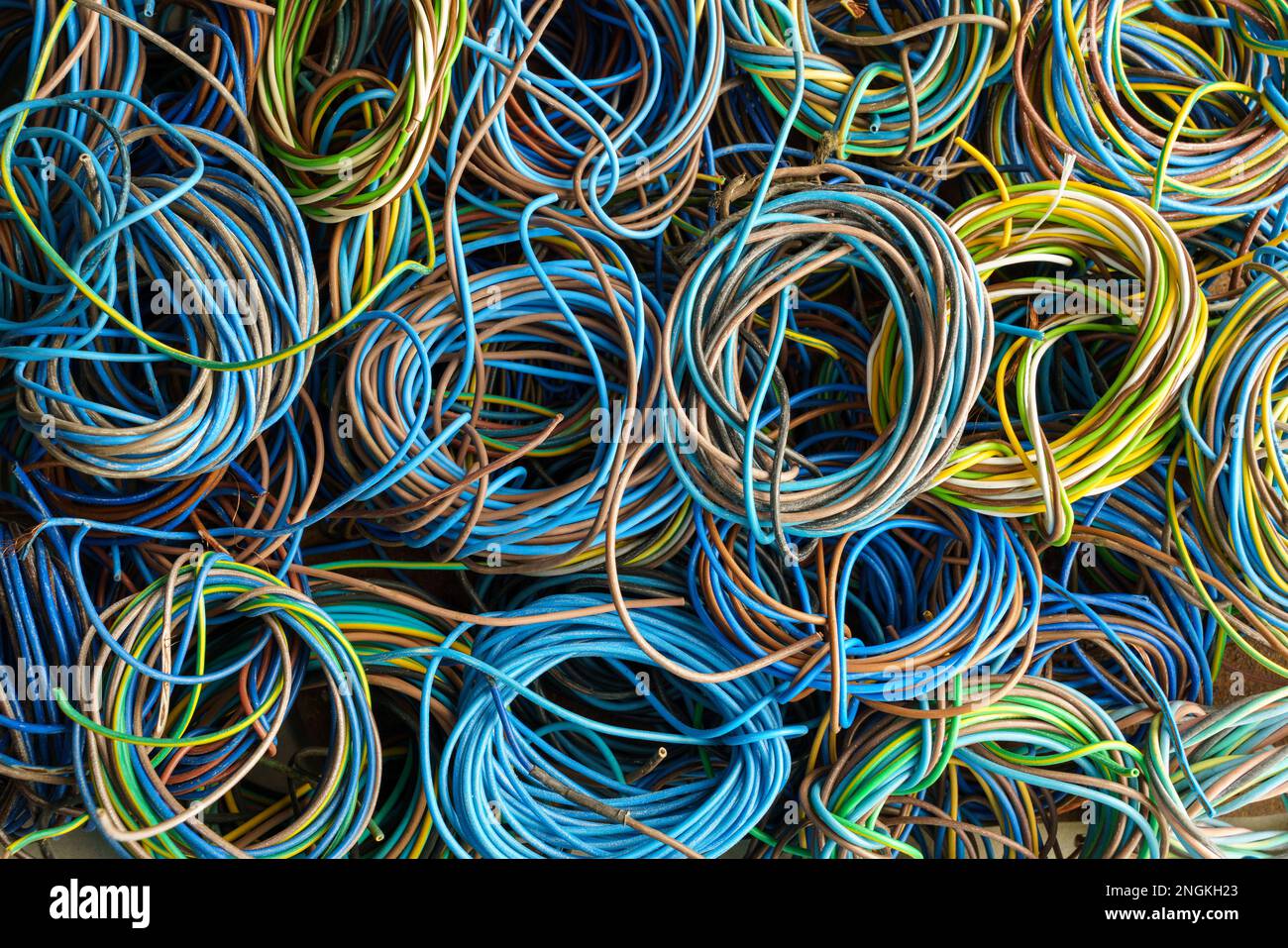 Colorful, coiled copper cables in rubber sheaths. Prepared for further