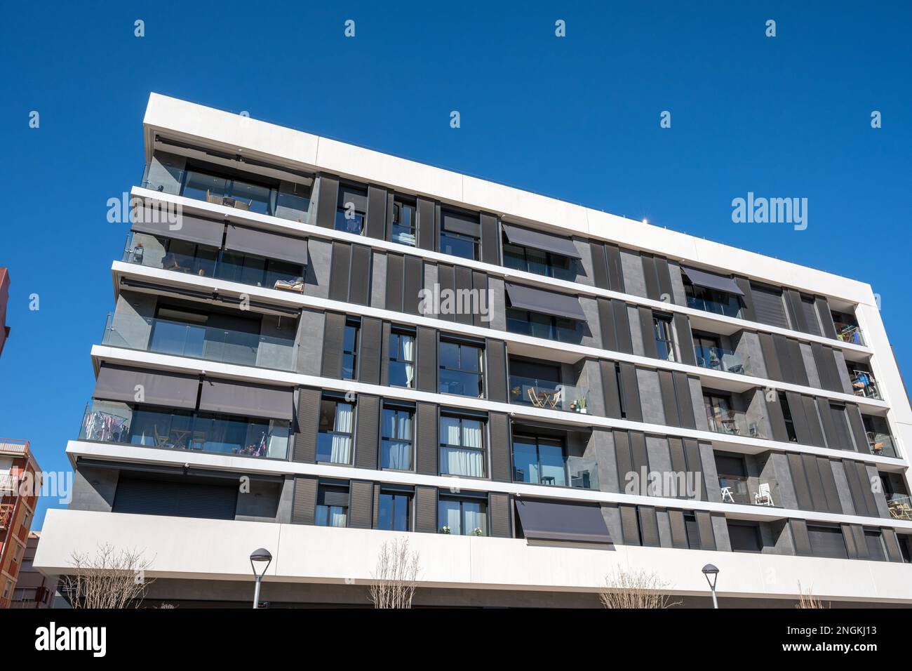 The facade of a modern white apartment building seen in Barcelona, Spain Stock Photo