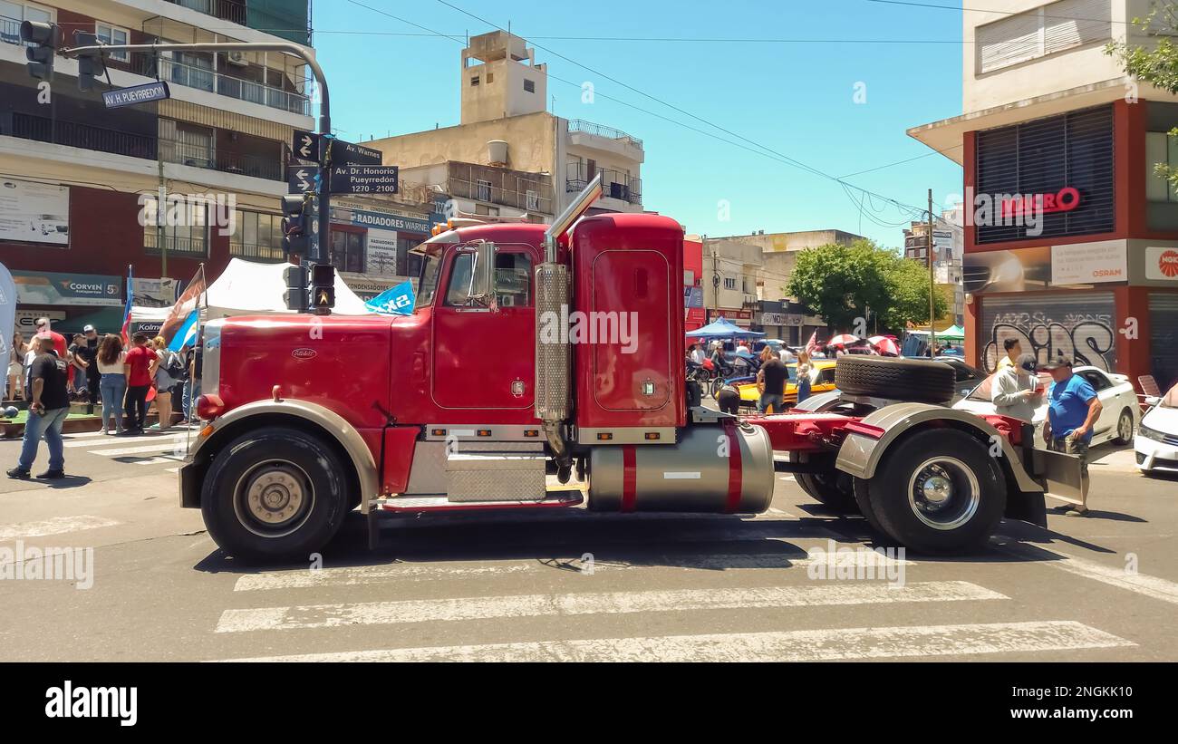 red Peterbilt 379 heavy duty cargo truck in the street. Expo Warnes 2022 classic car show. Sunny day. Side view. Stock Photo