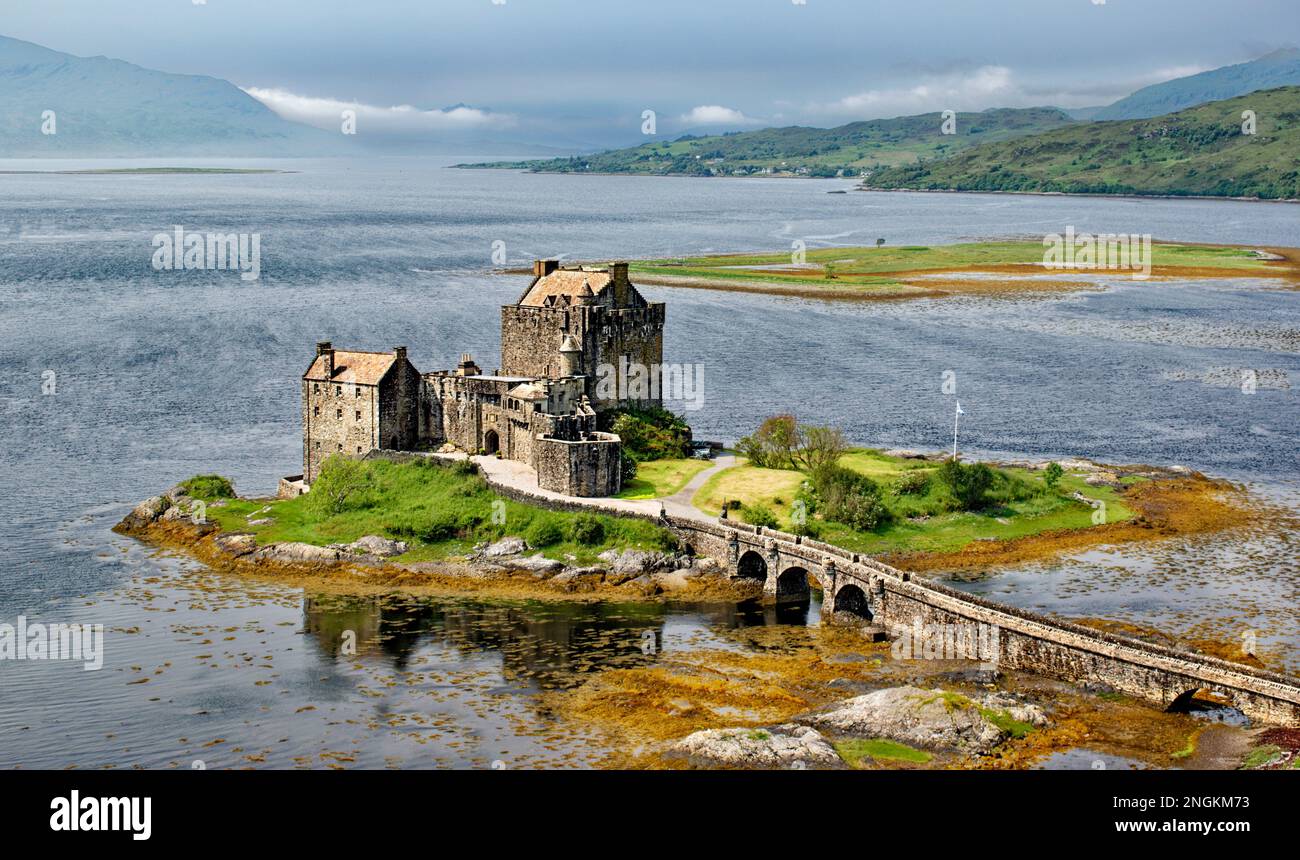 Eilean Donan Castle Loch Duich Scotland in June rain and clouds clearing the castle the loch and the bridge Stock Photo