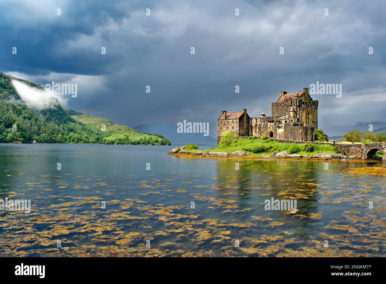 Eilean Donan Castle Loch Duich Scotland rain in June clearing the castle the loch and the bridge Stock Photo