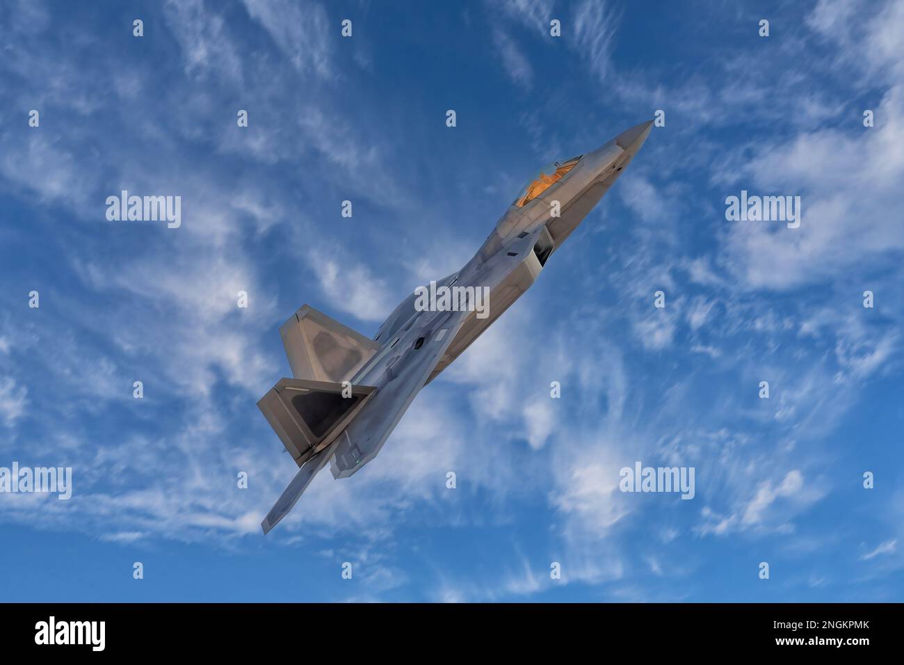 F-22 Raptor Armed Fighter Jet on a combat mission. F22 Raptor jet fighter warplane flying in front of the moon armed with sidewinders and missiles. Stock Photo