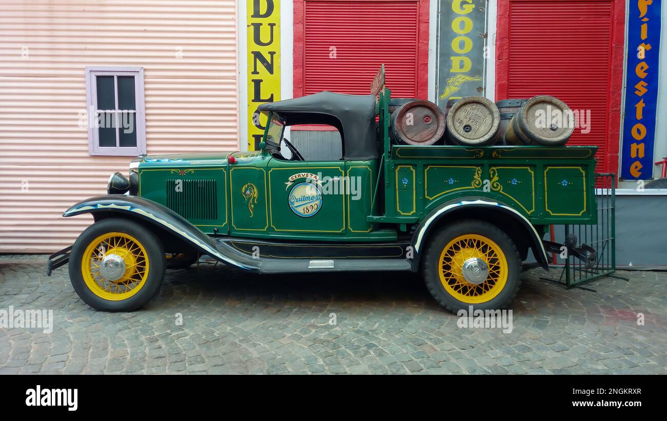 old green 1930 Chevrolet Chevy Six series AD Universal beer barrel pickup truck with fileteado artwork on a cobblestone street. Side view. Stock Photo