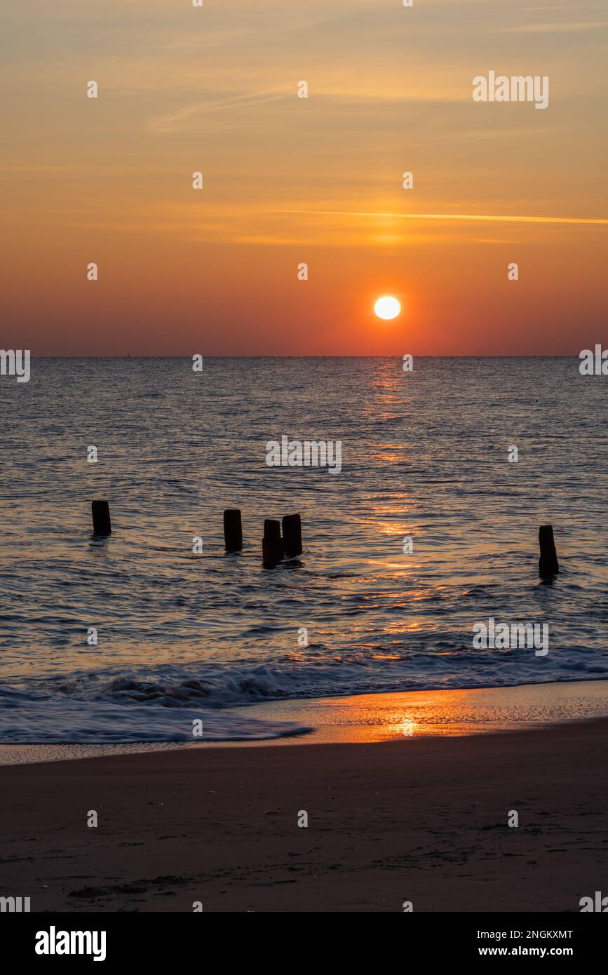 Waves gently lapping the shore at sunrise, Herring Point, Cape Henlopen State Park near Lewes, Delaware Stock Photo
