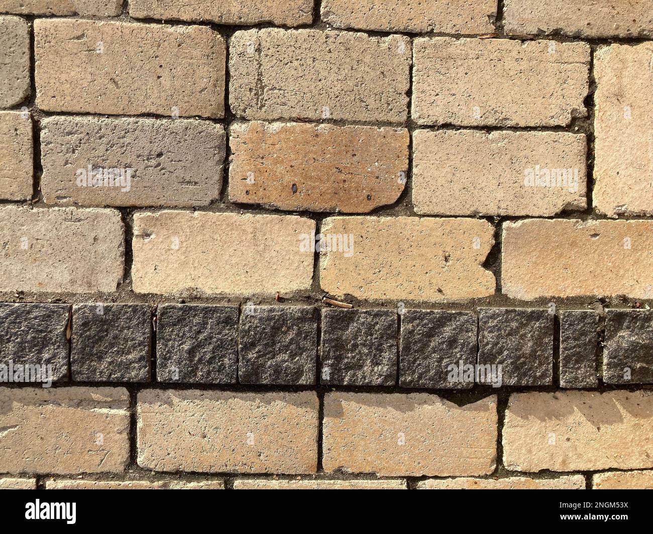 Yellow stone tiles masonry closeup background. the texture of yellow