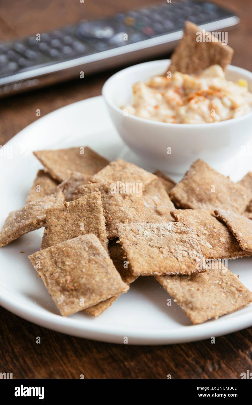 Homemade wheat thins, served with an onion dip and a remote control in