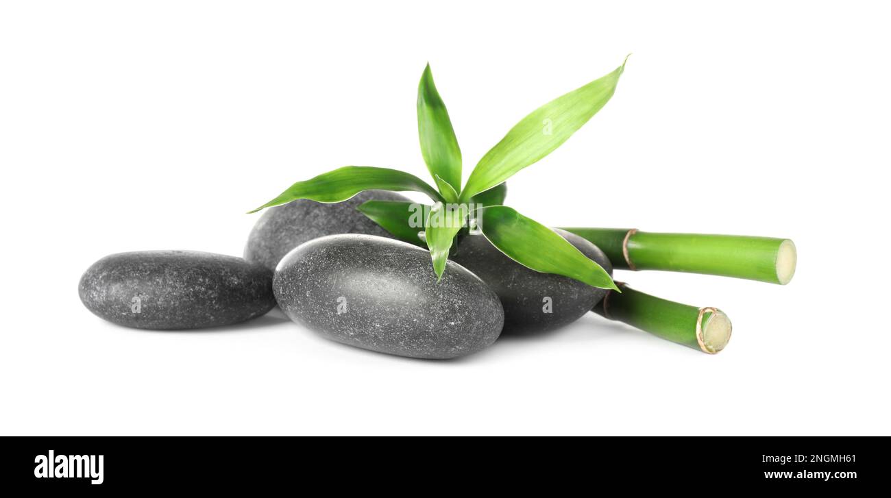 Spa stones and bamboo stems on white background Stock Photo - Alamy