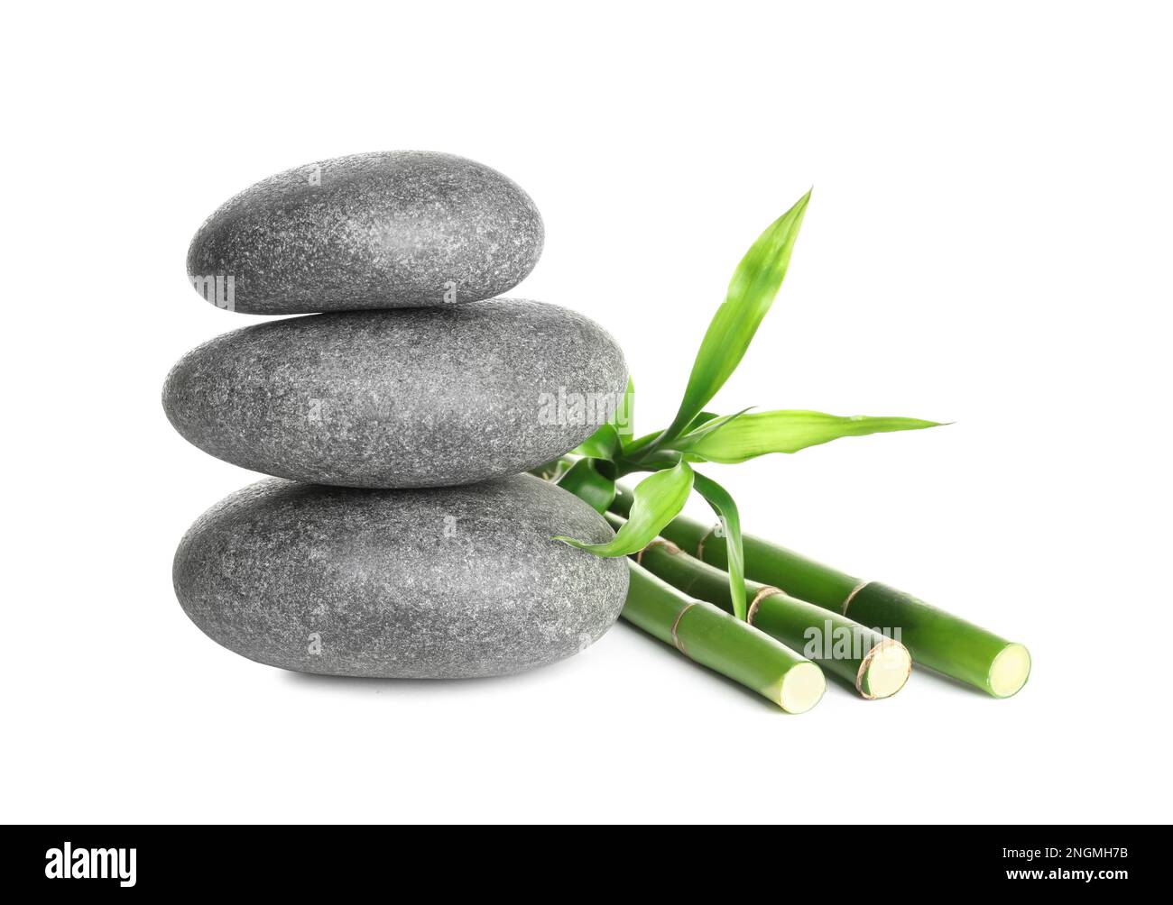 Stack of spa stones and bamboo stems on white background Stock Photo ...