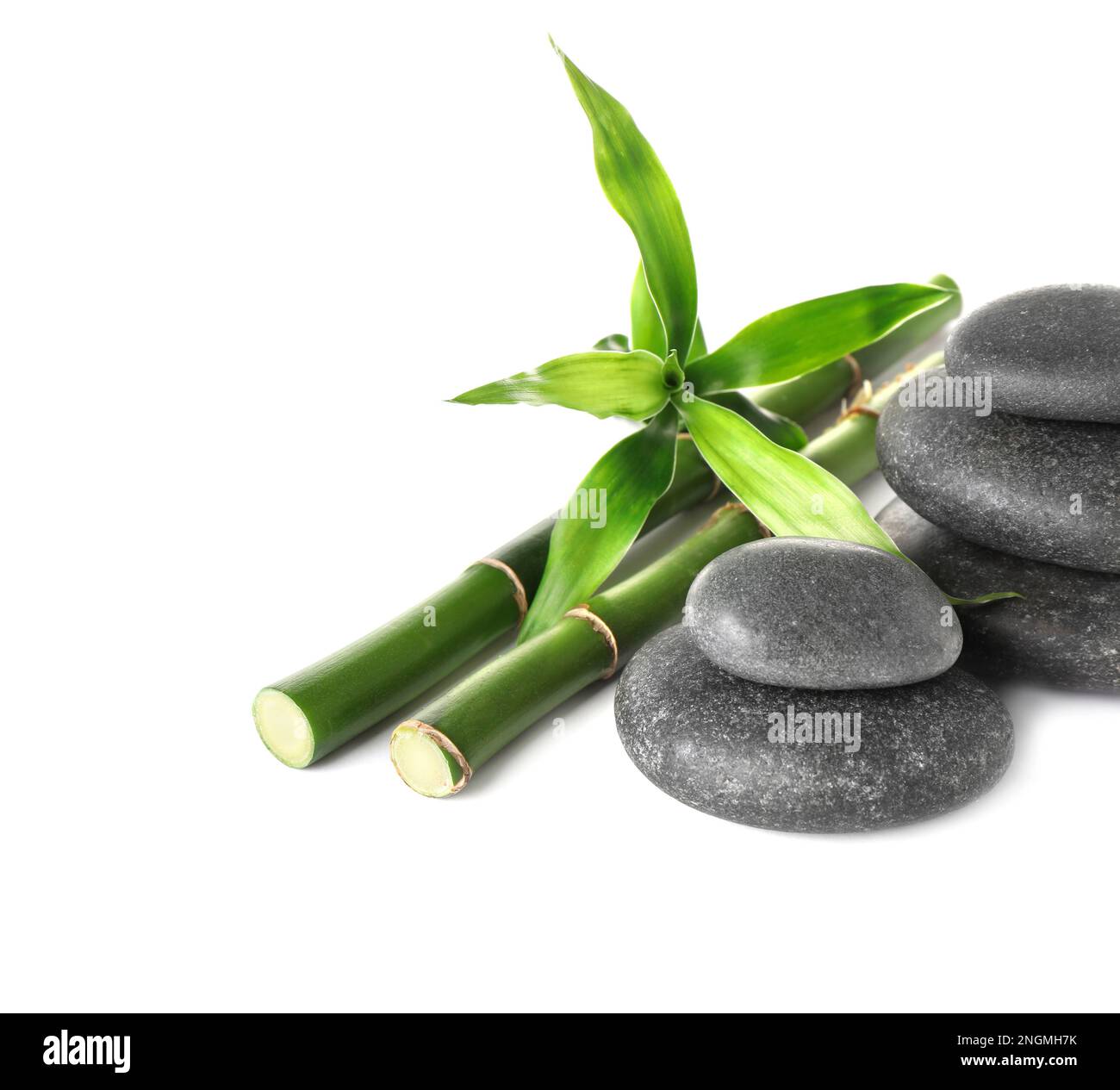 Spa stones and bamboo stems on white background Stock Photo - Alamy