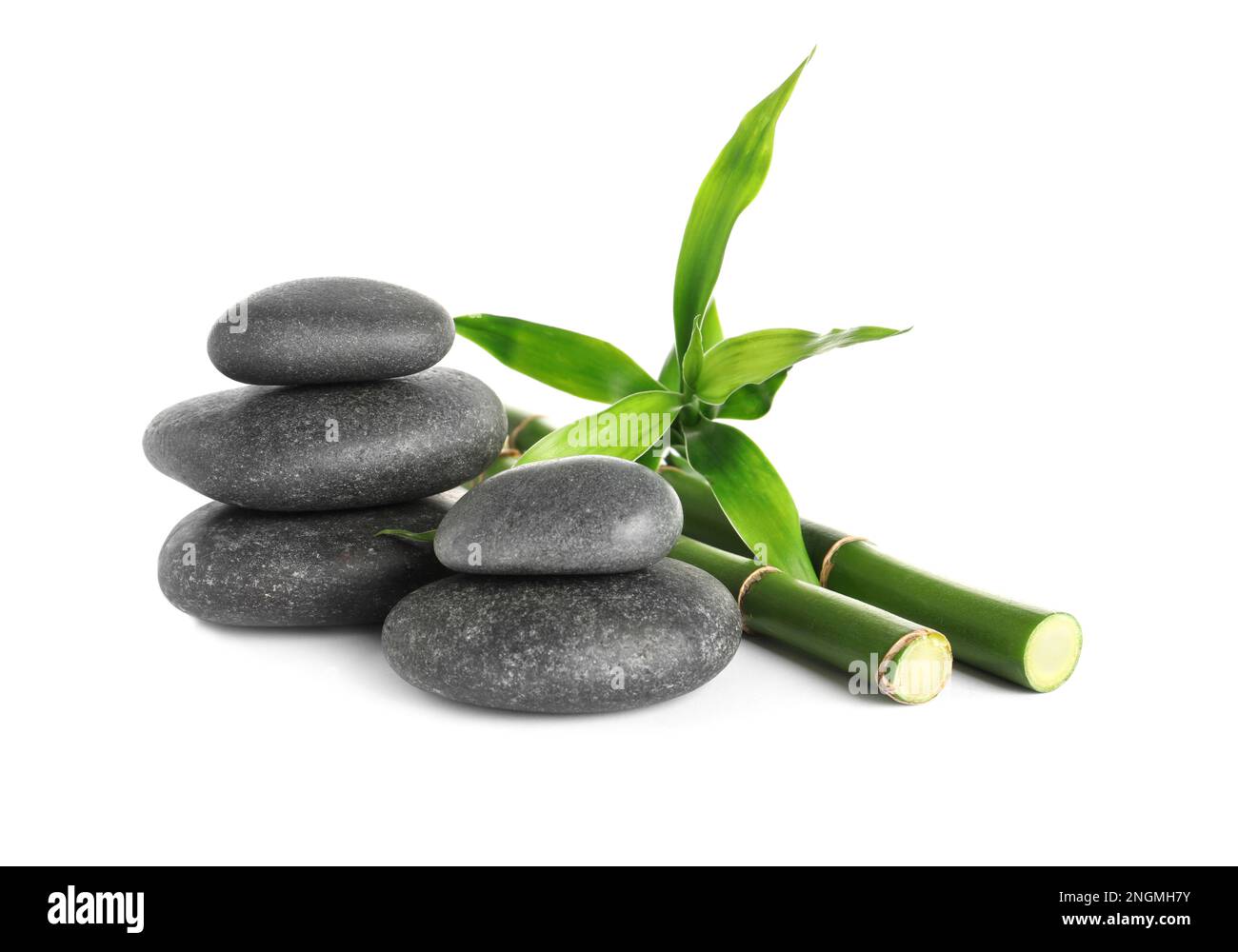 Spa stones and bamboo stems on white background Stock Photo - Alamy