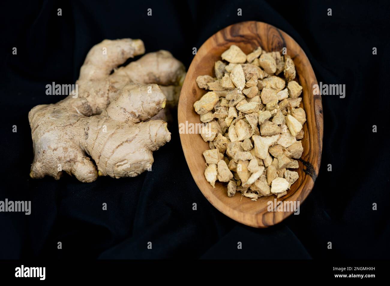 fresh ginger and dried ginger powder on olive wood Stock Photo
