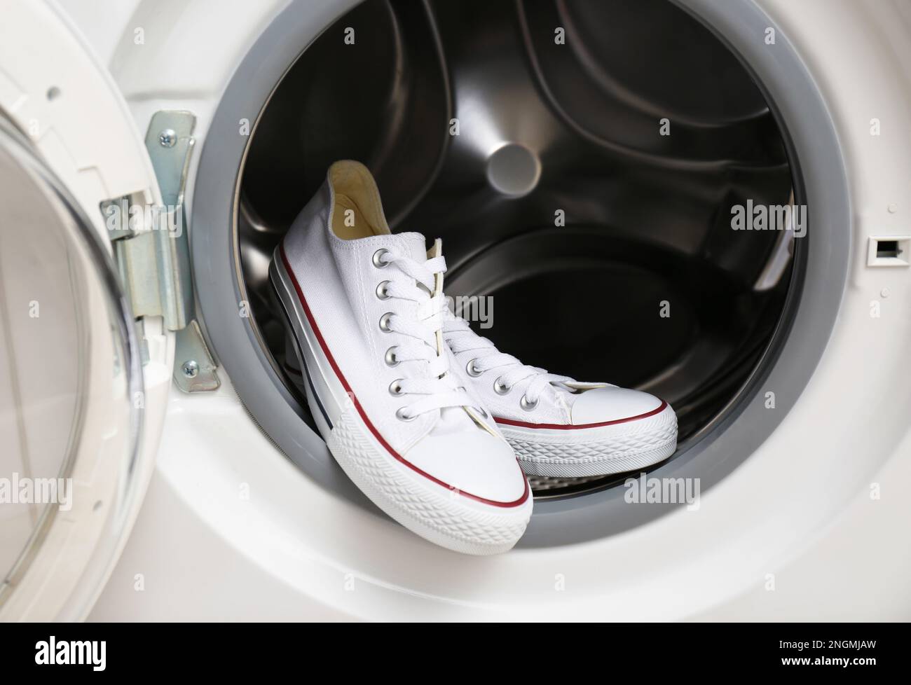 Clean sports shoes in washing machine drum Stock Photo Alamy