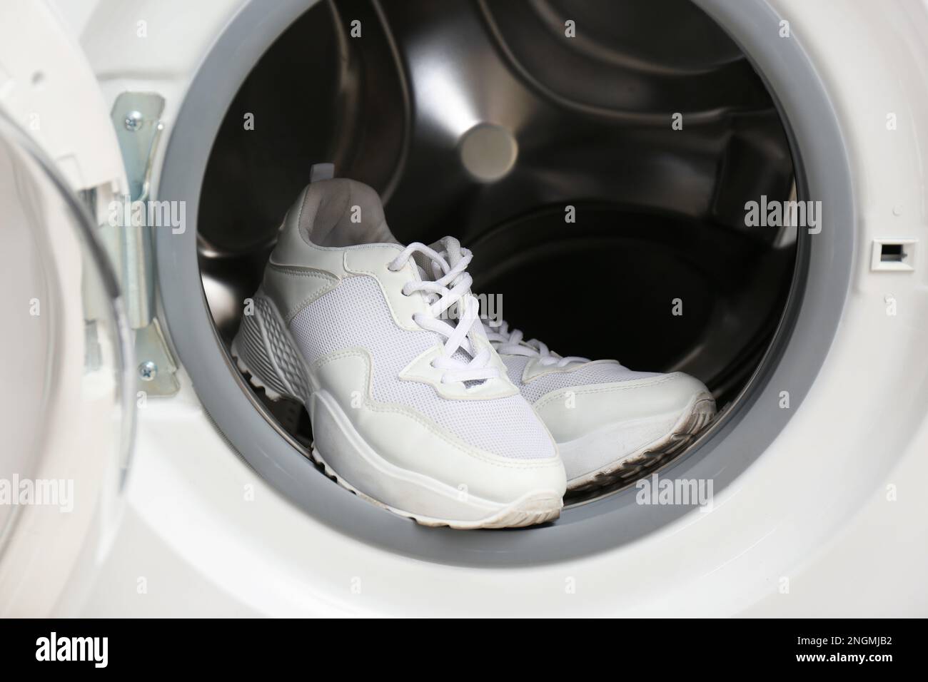Clean sports shoes in washing machine drum Stock Photo Alamy