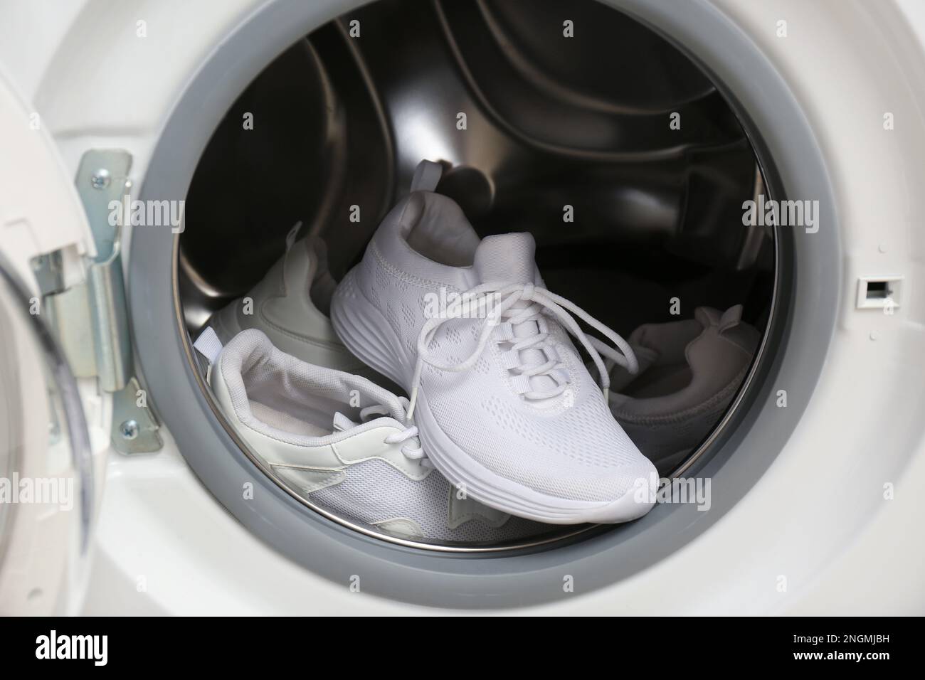 Clean sports shoes in washing machine drum Stock Photo Alamy