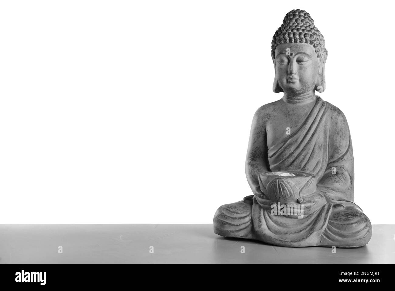 Beautiful stone Buddha sculpture on table against grey background