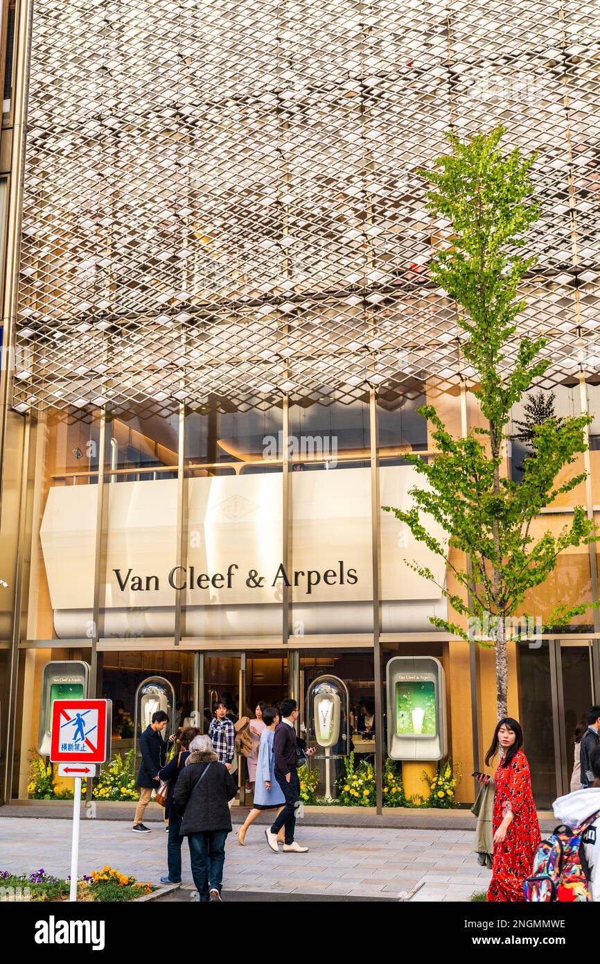 The Ginza Van Cleef and Arpels buildings with people walking by on a springtime weekend when the