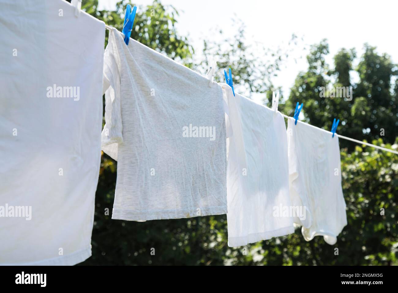 White laundry hanging string outdoors Stock Photo