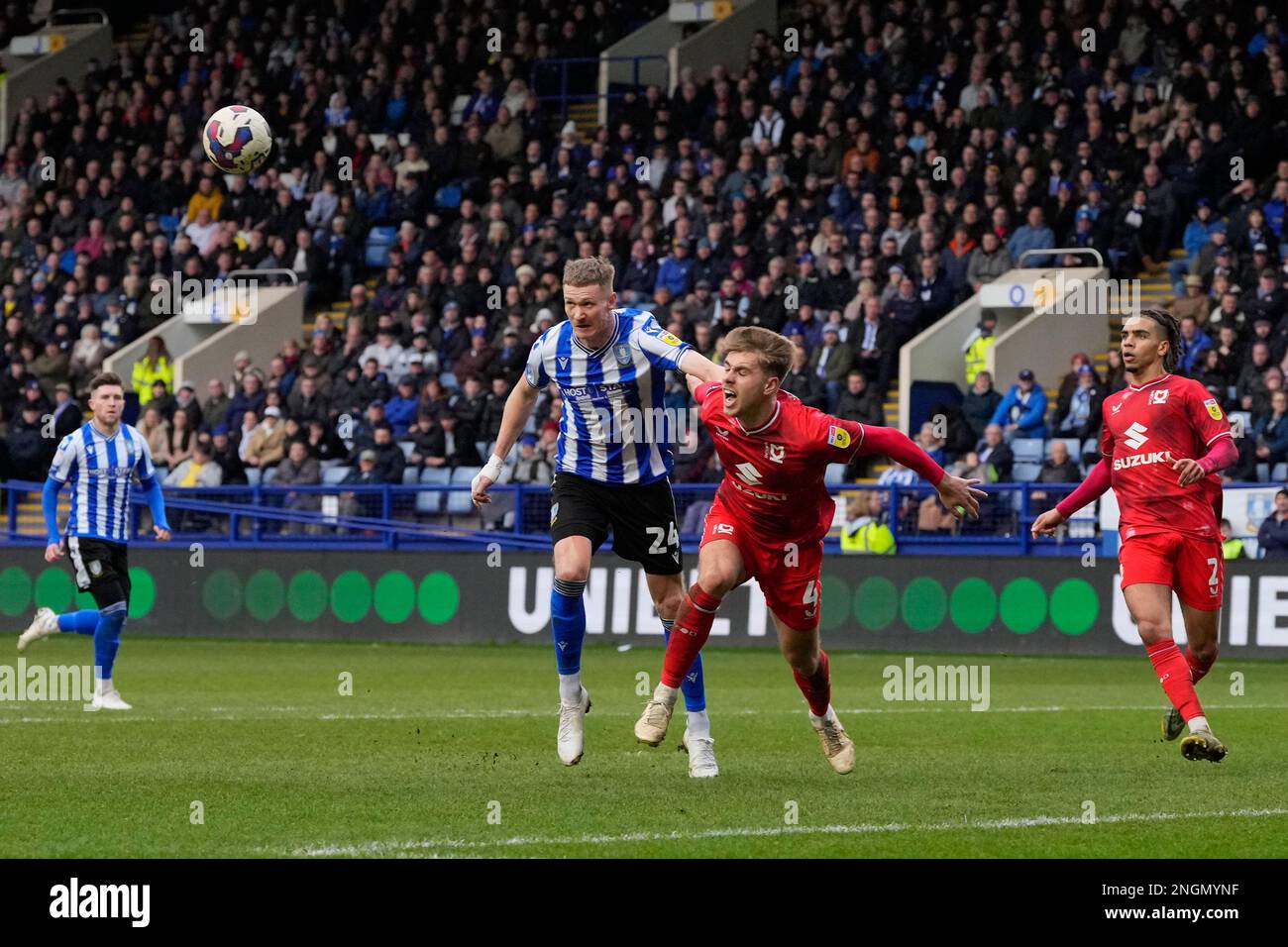 Sheffield, UK. 18th Feb, 2023. Jack Tucker #4 of MK Dons competes for a header with Michael Smith #24 of Sheffield Wednesday during the Sky Bet League 1 match Sheffield Wednesday vs MK Dons at Hillsborough, Sheffield, United Kingdom, 18th February 2023 (Photo by Steve Flynn/News Images) in Sheffield, United Kingdom on 2/18/2023. (Photo by Steve Flynn/News Images/Sipa USA) Credit: Sipa USA/Alamy Live News Stock Photo