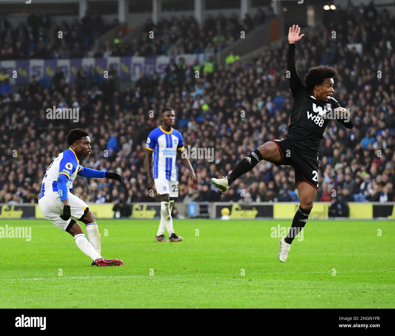 Brighton, UK. 18th Feb, 2023. Willian Borges Da Silva of Fulham FC jumps to stop the shot on goal by Tariq Lamptey of Brighton and Hove Albion during the Premier League match between Brighton & Hove Albion and Fulham at The Amex on February 18th 2023 in Brighton, England. (Photo by Jeff Mood/phcimages.com) Credit: PHC Images/Alamy Live News Stock Photo