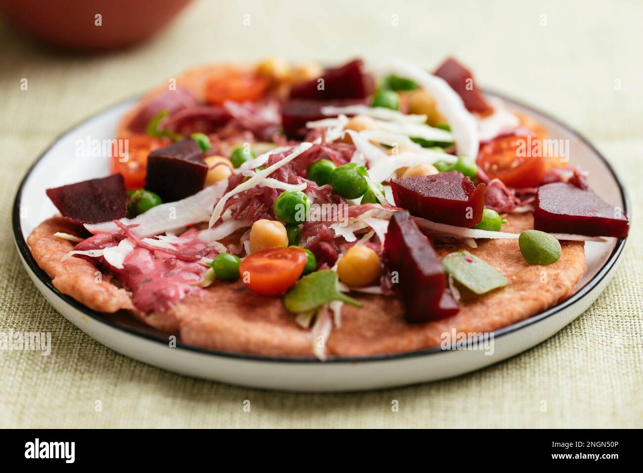 Homemade beet flatbreads with vegetables. Stock Photo