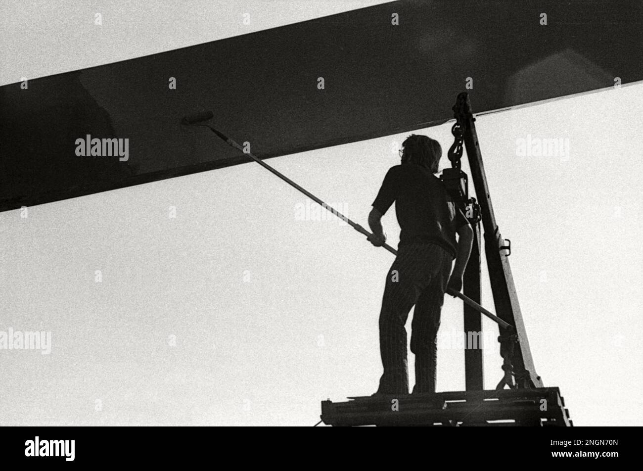 Construction workers on an outdoor site in 1971. Retro or vintage monochrome photograph Stock Photo
