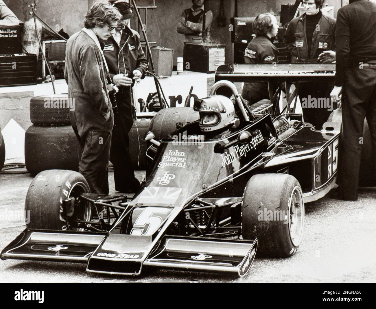 Racing Driver MARIO ANDRETTI seated in his John Player Special Lotus at box before a Formula 1 race Stock Photo