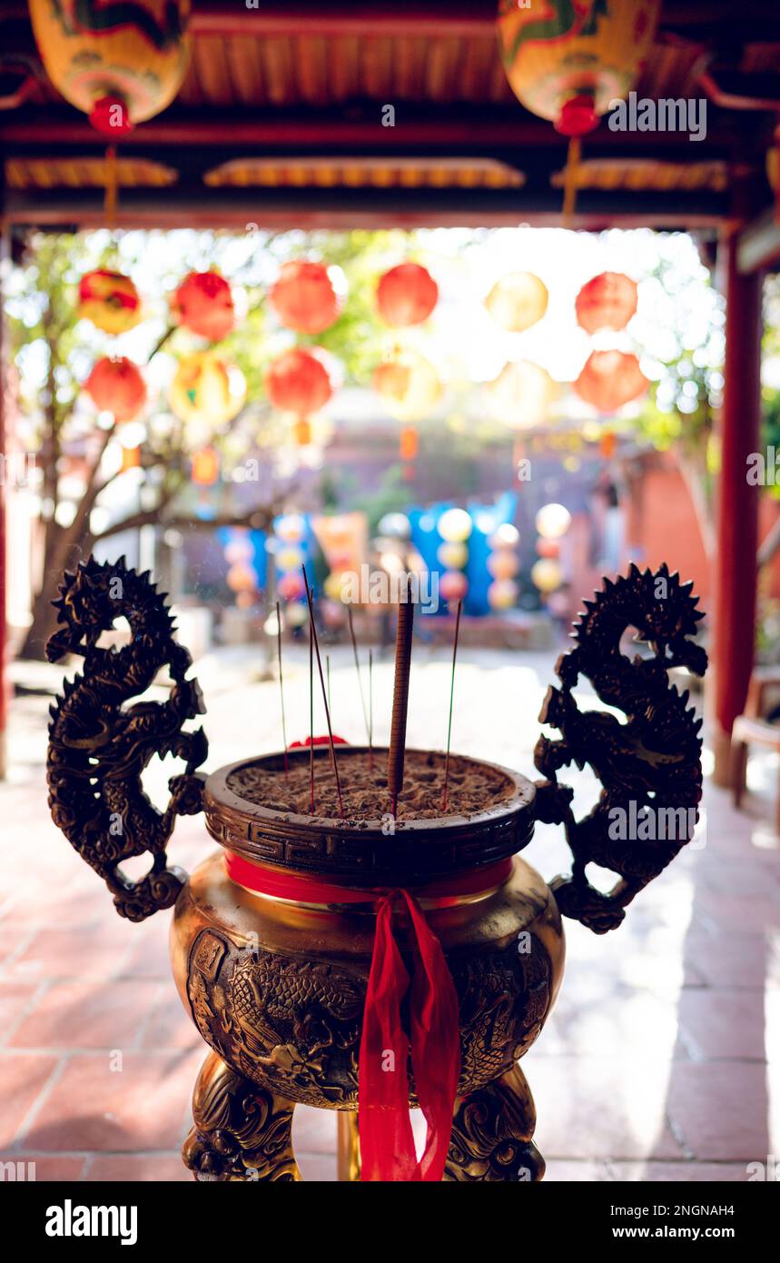 Incense burner in a temple. It's a Taoism temple. There are many lanterns in the background. Stock Photo