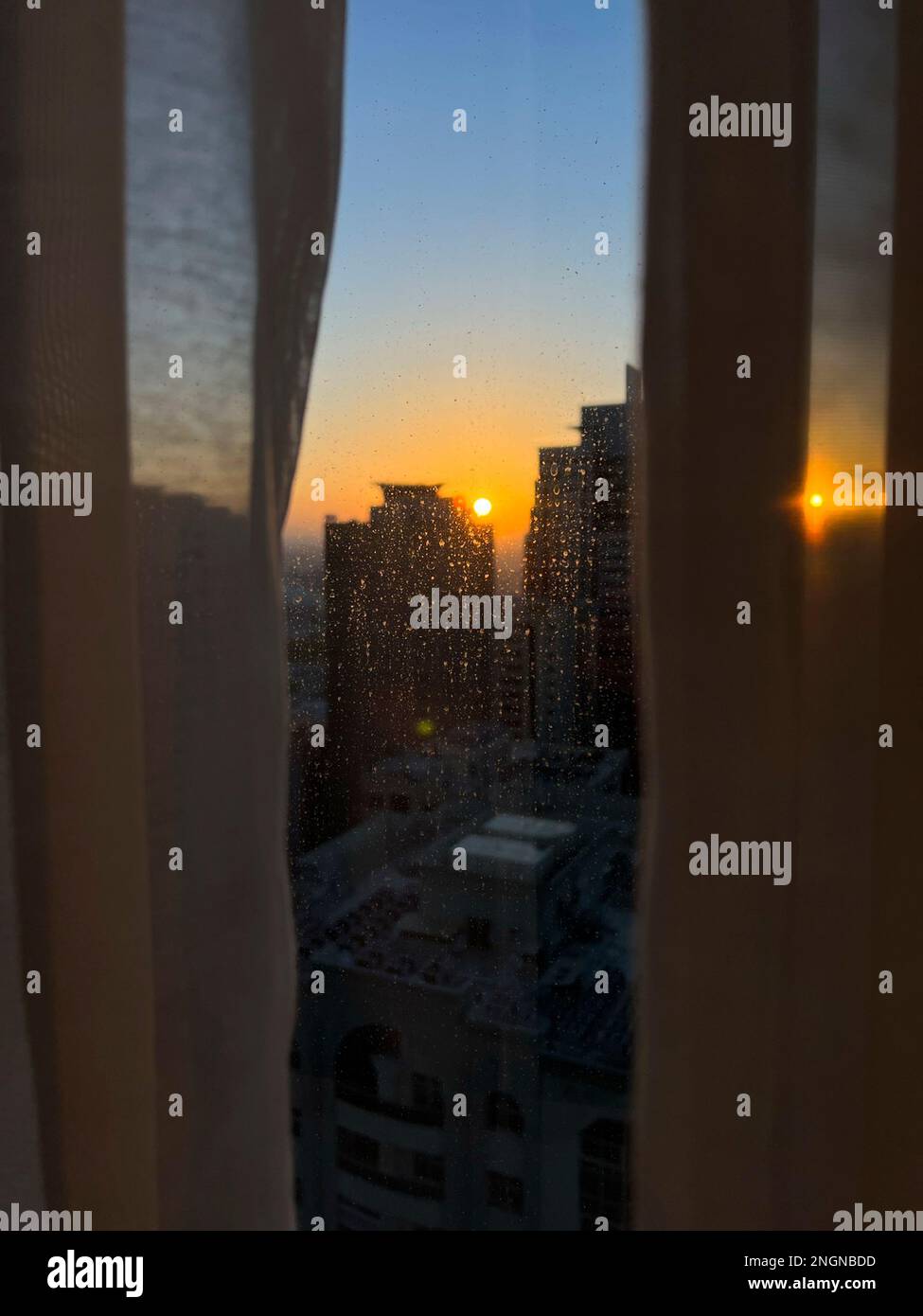 © 2023 John Angerson - Sunrise from the Pullman hotel, Sharjah, United Arab Emirates United Arab Emirates. Stock Photo