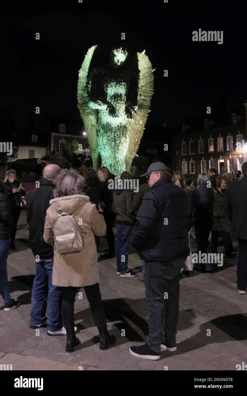 Gloucester, UK. 18th Feb, 2023. People gather around the Knife Angel outside Gloucester Cathedral to remember Holly Gazzard who was murdered by a former boyfriend on this day in 2014. Holly's family have since become campaigners against domestic abuse promoting education on healthy relationships to schools and colleges. The Knife Angel is a 27ft sculpture made of 100,000 blades seized by the Police. Knife Angel is on a national tour to raise awareness of the perils of knife crime. Credit: JMF News/Alamy Live News Stock Photo