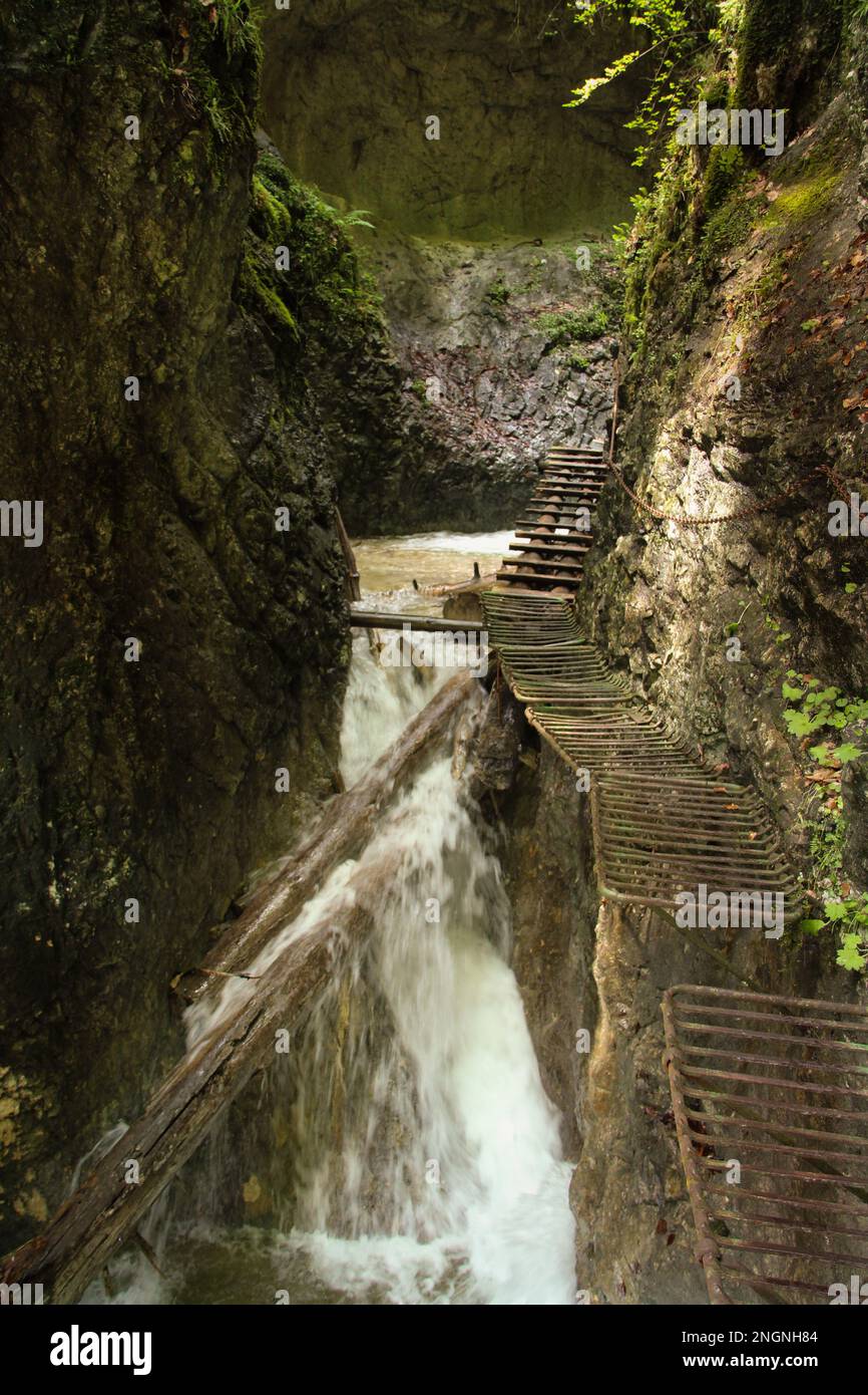 Dangerous trail through a waterfall with wooden ladders in the Slovak